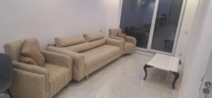 ein Wohnzimmer mit einer Couch und zwei Sesseln in der Unterkunft Locker in Prizren