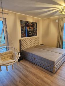 a bedroom with a large bed and a painting on the wall at Abbey View Suites in Echternacherbrück