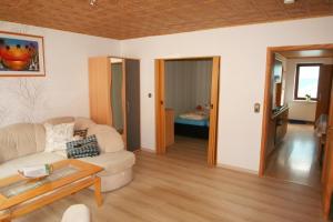 a living room with a couch and a table at Mönch in Harztor