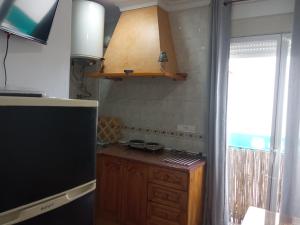 a kitchen with a counter top and a refrigerator at La Casita 18 in Ardales