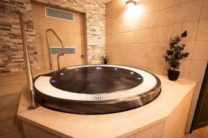 a large bath tub in a bathroom with a sink at Aparthotel Mádr in Modrava