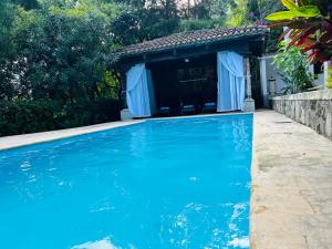 a house with a swimming pool in front of a house at Casa Verapaz in Santa Catarina Palopó +25 photos