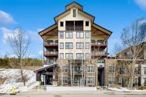 a large apartment building with a tower at Ski-In Ski-Out Modern Mountain Condo in Winter Park