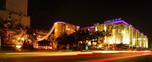 a city street at night with buildings and palm trees at Wego Hotel - Linsen in Taipei