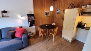 a living room with a blue couch and a table at Yvonne Mayer in Scuol