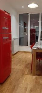 a room with a red refrigerator and a table at Queen Barbara in Genoa +13 photos