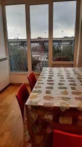 a room with a table with chairs and a large window at Queen Barbara in Genoa