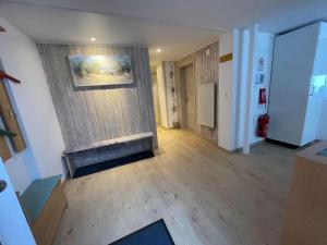 a living room with a fireplace and a wall at Ferienwohnung Hälmli in Heiden