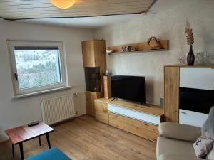 a living room with a tv and a couch at Ferienwohnung Tirol in Landeck