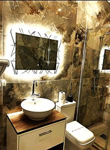 a bathroom with a sink and a toilet at APART-HOTEL PRESiDENT 2 in Ulcinj