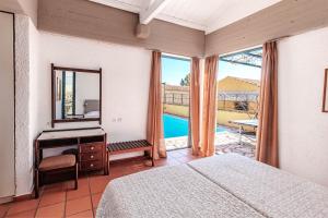 a bedroom with a mirror and a dressing table and a mirror at Barbati Beach - Villa Lefkada in Barbati