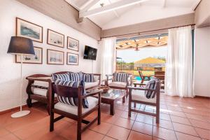 a living room with a table and chairs and a patio at Barbati Beach - Villa Lefkada in Barbati