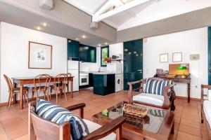 a living room with a couch and a table at Barbati Beach - Villa Lefkada in Barbati
