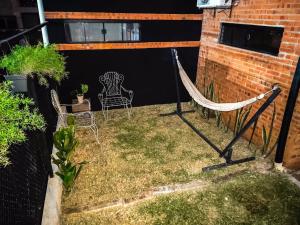 a hammock in the backyard of a house at Habitación standard - SKYHOME I in Luque
