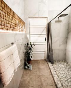 a bathroom with a shower and a white door at Habitación standard - SKYHOME I in Luque +12 photos