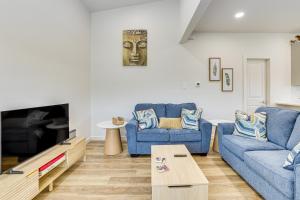 a living room with two blue couches and a tv at Great for Travel Nurses 2BR East Dallas Townhome! in Dallas