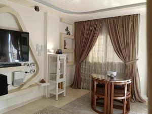 a living room with a table and a window at Madinty Stylish Stay in B6 in Madinaty
