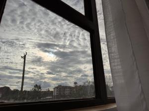 a window with a view of a cloudy sky at Harlem Suites in Kiambu