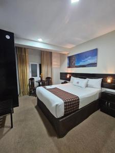 a hotel room with a large bed and a television at TerraMistica - Puno Centro in Puno