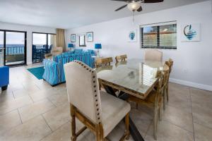 a dining room and living room with a table and chairs at Surf Dweller 312 Large gulf front in Fort Walton Beach