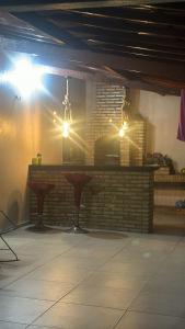 a bar in a room with a brick wall at Chácara Santa Terezinha in Quixeramobim