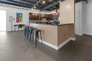 a kitchen with a bar with stools in a room at 3 BR 2 BA Downtown Loft water view in Fort Walton Beach