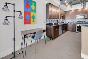 a kitchen with a wooden table and a blue chair at 3 BR 2 BA Downtown Loft water view in Fort Walton Beach