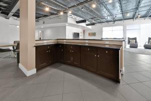 a large room with a kitchen with a counter top at 3 BR 2 BA Downtown Loft water view in Fort Walton Beach +35 photos