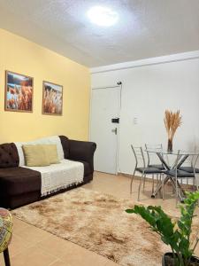 un salon avec un canapé et une table dans l'établissement Apê moderno com garagem - Campo Novo, perto do Shopping Caruaru, à Caruaru