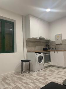 a kitchen with a washing machine and a table at Othono &Theonos Walled City Studio in Nicosia +5 photos