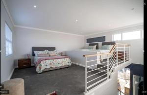 a bedroom with two bunk beds and a staircase at Ships Bell at Port St Francis in St Francis Bay +57 photos