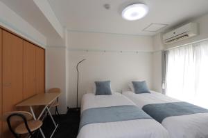 Ένα ή περισσότερα κρεβάτια σε δωμάτιο στο 森下ビル302