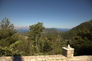 a stone wall with a view of the mountains at Sommer Dafnopanagia Villa Magda in Káto Exánthia +32 photos