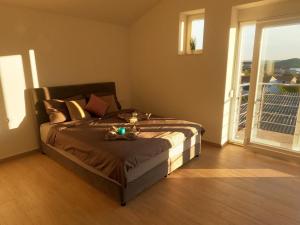 a bedroom with a bed with a candle on it at Modernes Ferienhaus Mit Eigenem Pool Und Meerblick in Bilice