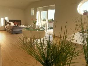 a living room with a table and a couch at Modernes Ferienhaus Mit Eigenem Pool Und Meerblick in Bilice