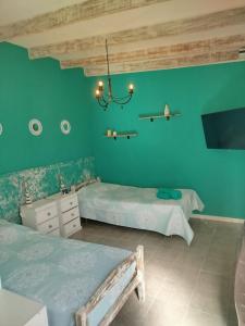 Ένα ή περισσότερα κρεβάτια σε δωμάτιο στο Refugio Urbano