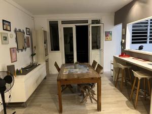 a kitchen and dining room with a wooden table at Cap Lodge in Le Marin