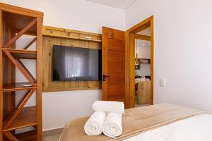 Ένα ή περισσότερα κρεβάτια σε δωμάτιο στο Arraial | Apê estilo rústico chic na rua do Mucugê +35 φωτογραφίες