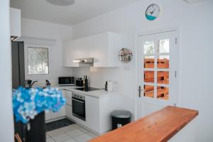 a kitchen with white walls and a wooden table at Villa Aphrodite in Paradise Gardens - 3bd with Private Pool by VICHY Holidays in Nea Paphos