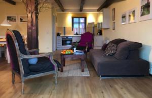a living room with a couch and a table at Ferienhaus Im Idyllischsten Winkel Rügens in Neuenkirchen