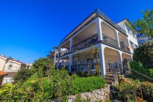 a white house with a balcony at Apartments Marija in Senj