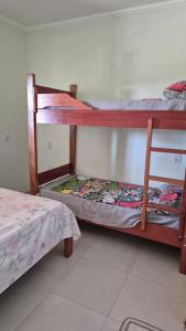 two bunk beds in a room with a bed at Chácara Nonna Rosa in Socorro +55 photos