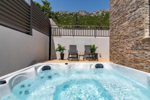 a jacuzzi tub in the backyard of a house at Villa Eden with heated pool in Omiš