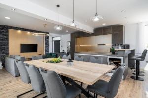 a kitchen and dining room with a wooden table and chairs at Villa Eden with heated pool in Omiš