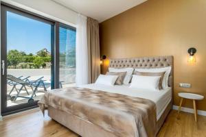 a bedroom with a large bed and a large window at Villa Eden with heated pool in Omiš +43 photos