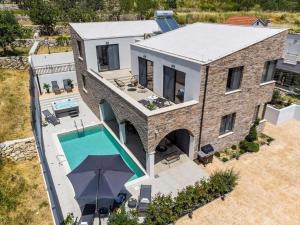 an aerial view of a house with a swimming pool at Villa Eden with heated pool in Omiš