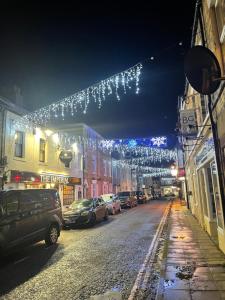 a street with christmas lights hanging over a street at Hope Corner in Filey