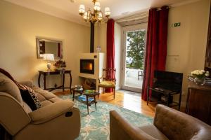 ein Wohnzimmer mit Sofa und Fernseher in der Unterkunft Ferienhaus für 4 Personen ca 120 qm in Algarvia, Azoren Sao Miguel in Algarvia