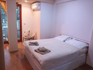 a bedroom with a bed with two towels on it at Apartment Riki 2 in Ohrid