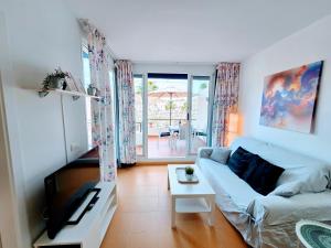 a living room with a couch and a table at Canary Dreams Ocean View in Playa del Cura